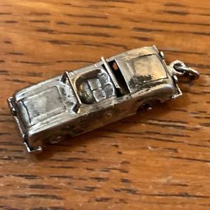 Sterling vintage car with movable wheels and top opens and closes